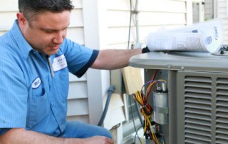 Technician fixing an air conditioner for spring savings in Milwaukee & nearby areas