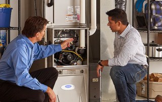 Technician performing fall maintenance on a furnace in Milwaukee & nearby areas