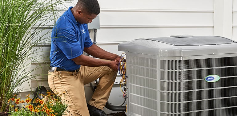HVAC technician installing a new air conditioner