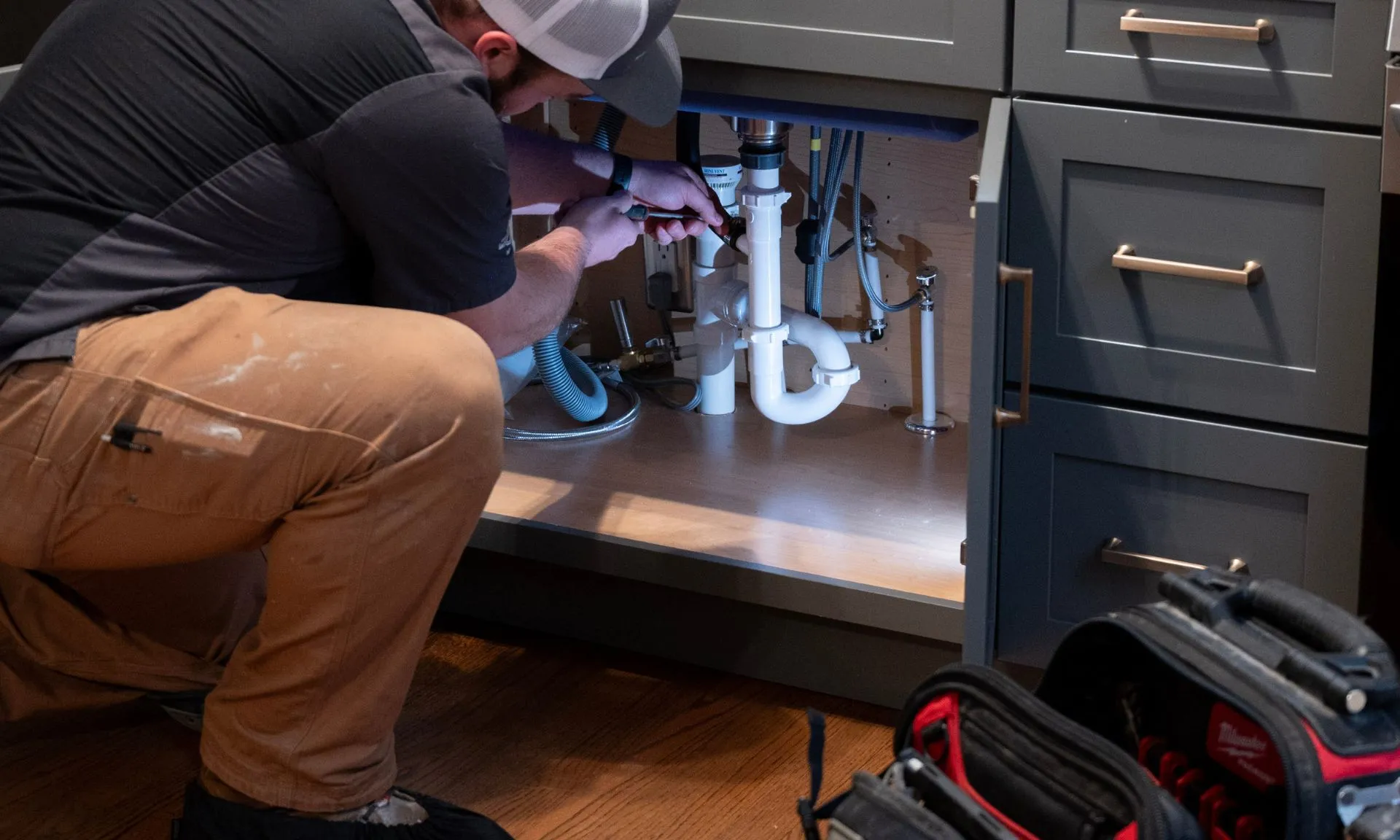 Plumbing_Technician_Performing_Drain_Service Drain Cleaning Services in Milwaukee, WI